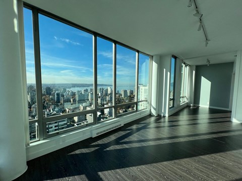 a view of a city skyline from a living room with windows