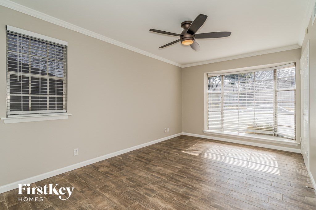a living room with a ceiling fan and a window