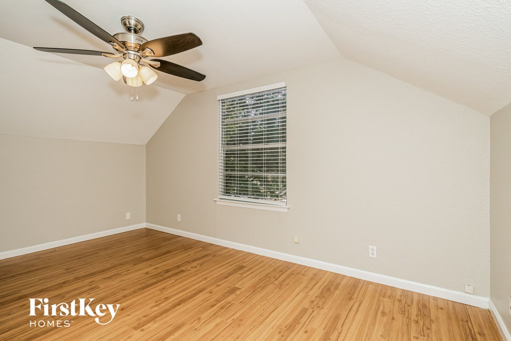a living room with hardwood floors and a ceiling fan