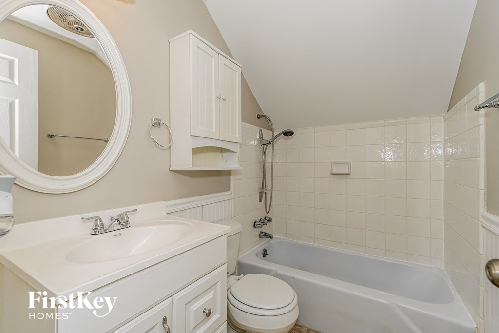 a white bathroom with a sink toilet and bath tub