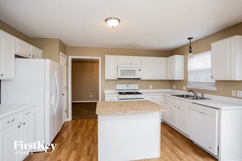 a kitchen with white cabinets and a counter top