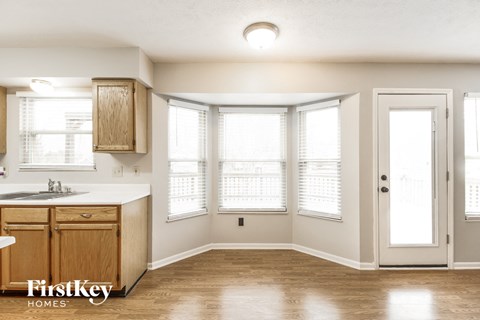 A kitchen with wooden cabinets and a sink is shown.