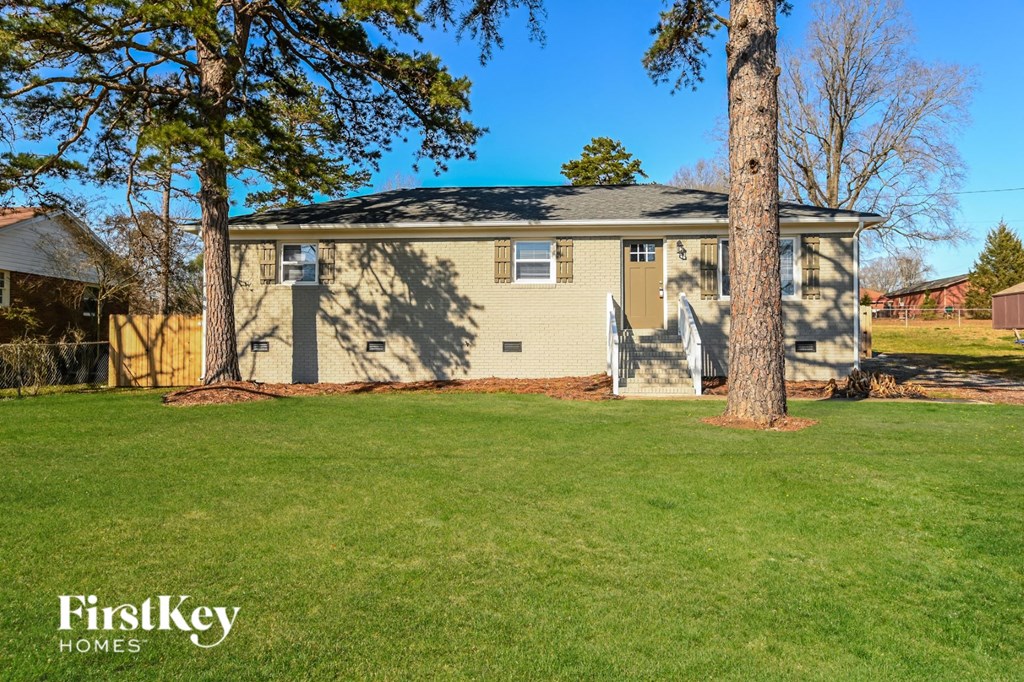 A house with a tree in front of it.
