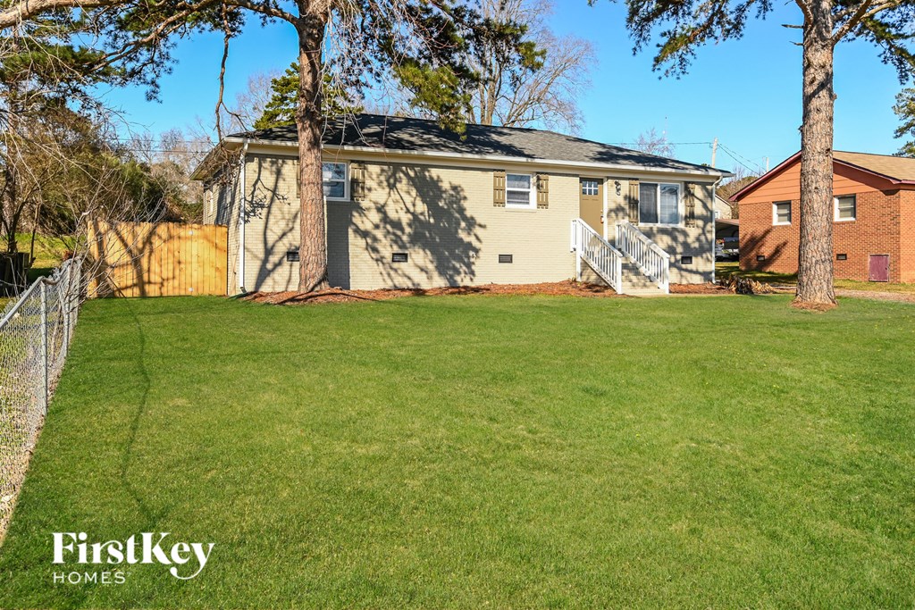 A house with a lawn in front of it.