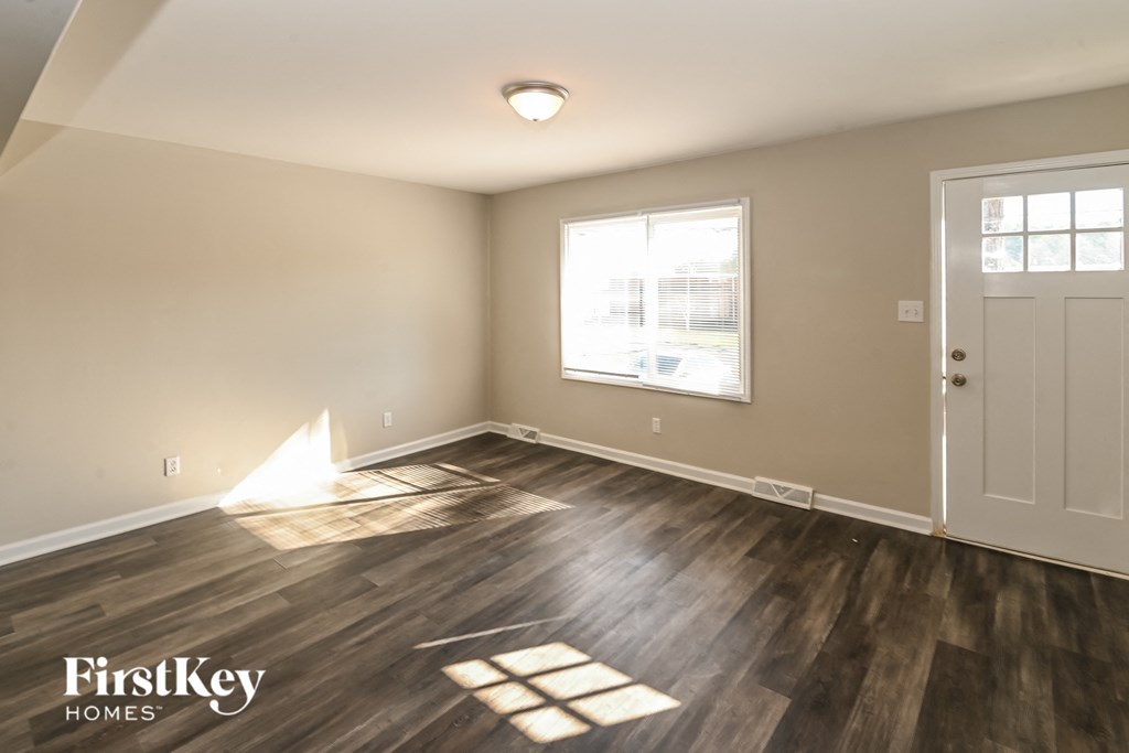 A room with wooden floors and a white door.