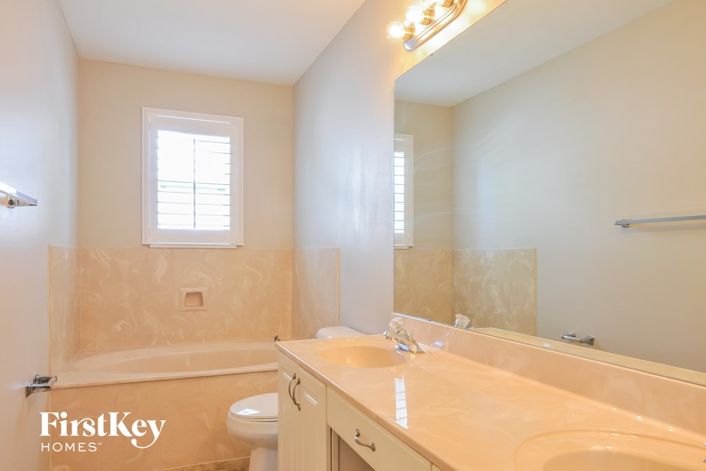 a bathroom with a sink and a toilet and a tub