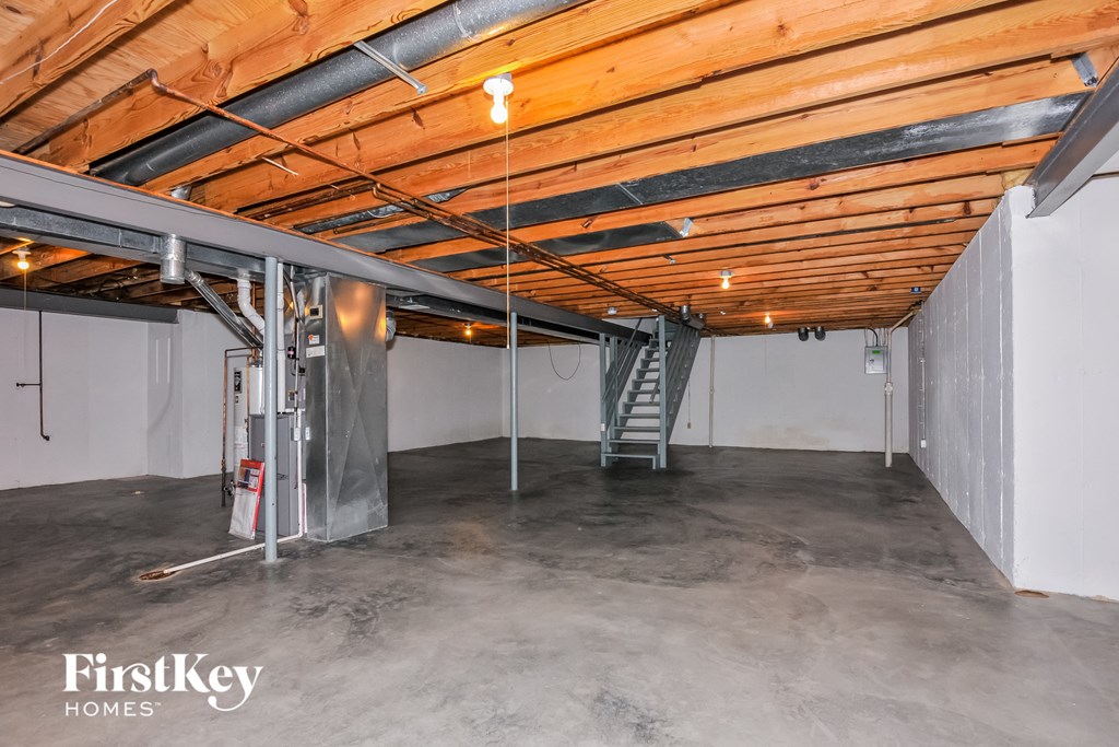 a garage with concrete floors and a ladder in the corner
