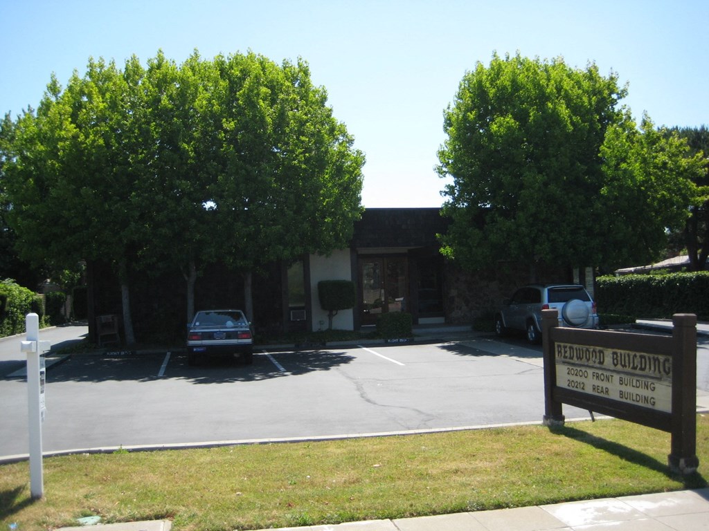 a parking lot in front of a building with a church sign
