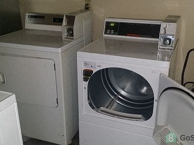 a washing machine and a dryer in a room