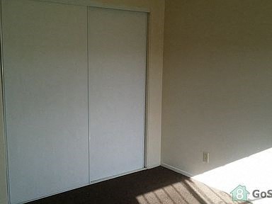 an empty room with white walls and a window