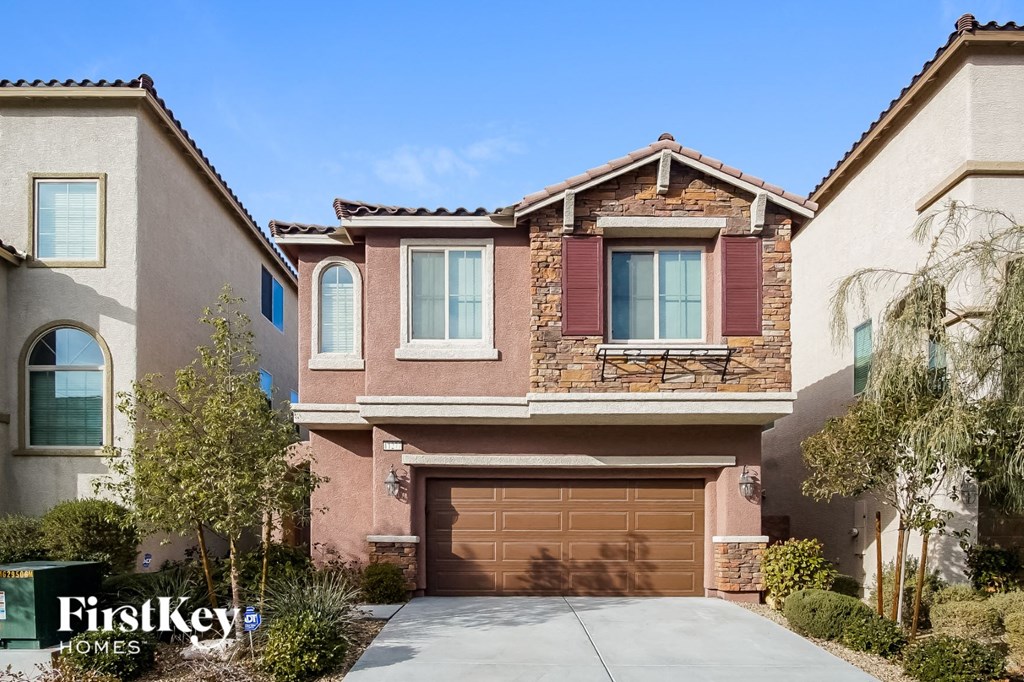 a house with a garage door in front of it