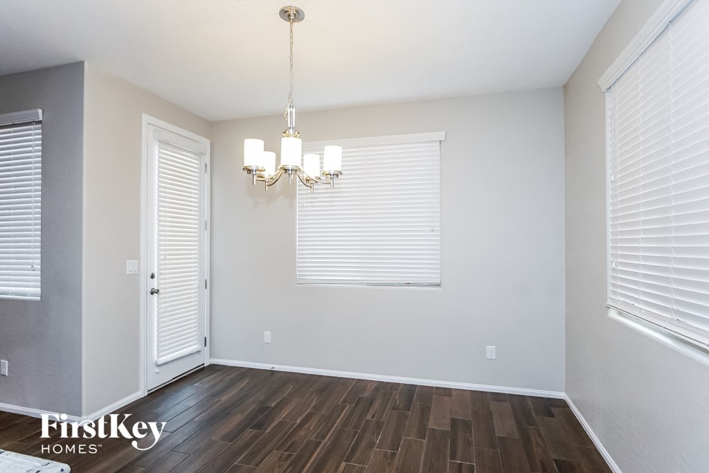 a dining room with a chandelier and a window