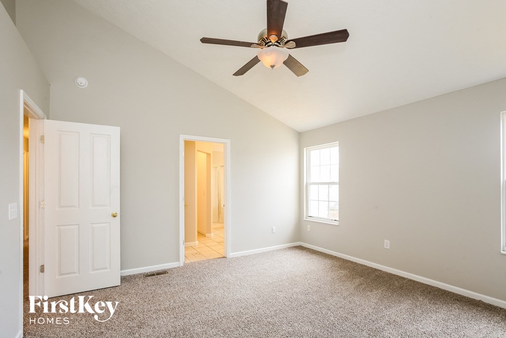 the master bedroom is spacious and has a ceiling fan