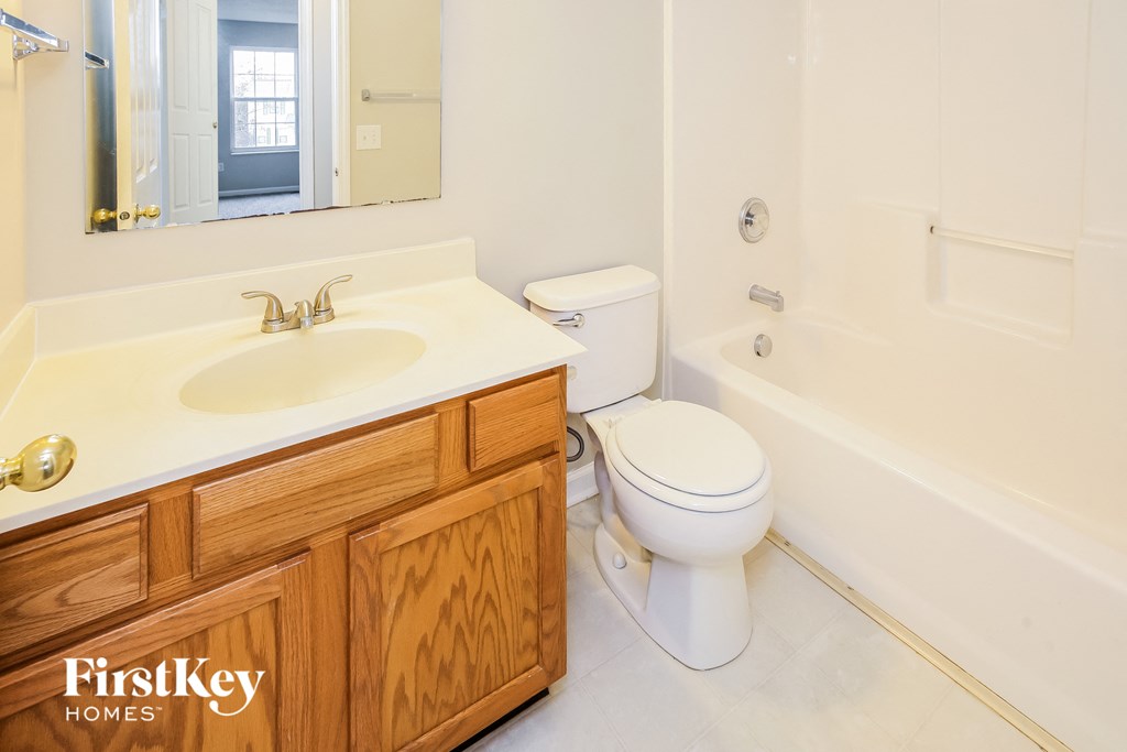 a bathroom with a sink toilet and a bath tub