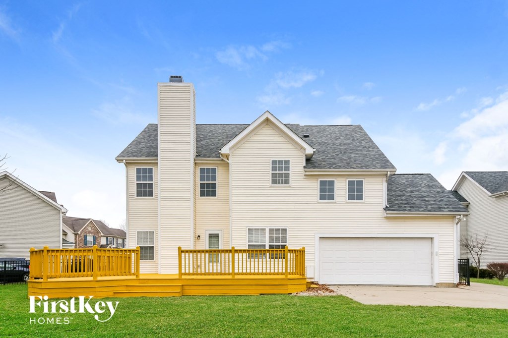 a house with a wooden fence in front of it
