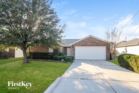 a home with a white garage door and a driveway