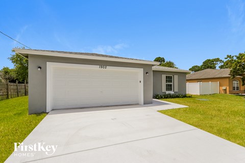 a home with a white garage door and a driveway