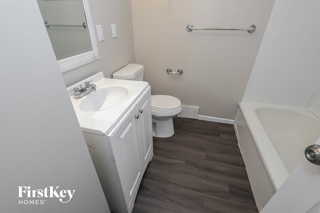 a bathroom with a sink toilet and a bath tub