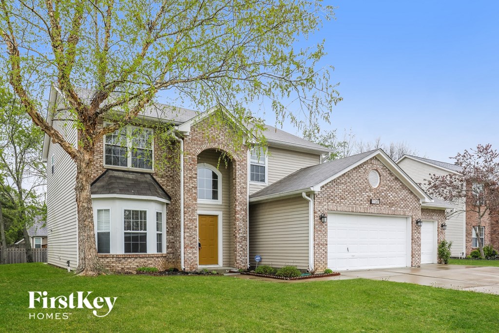 A house with a brick facade and a garage door.