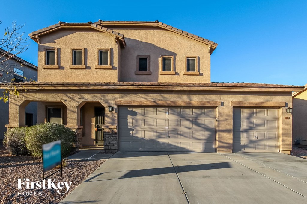 a house with two garage doors and a driveway