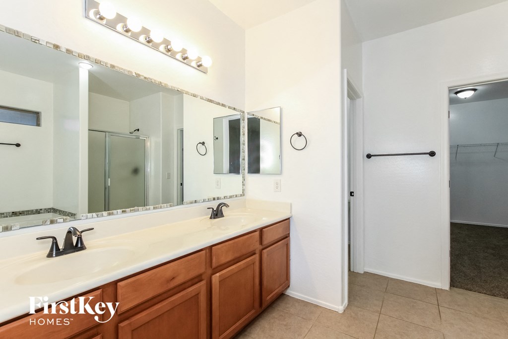 a bathroom with two sinks and a large mirror