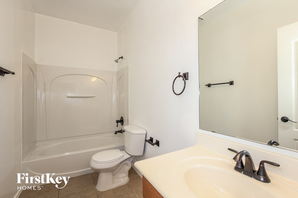 a bathroom with a sink and a toilet and a bath tub