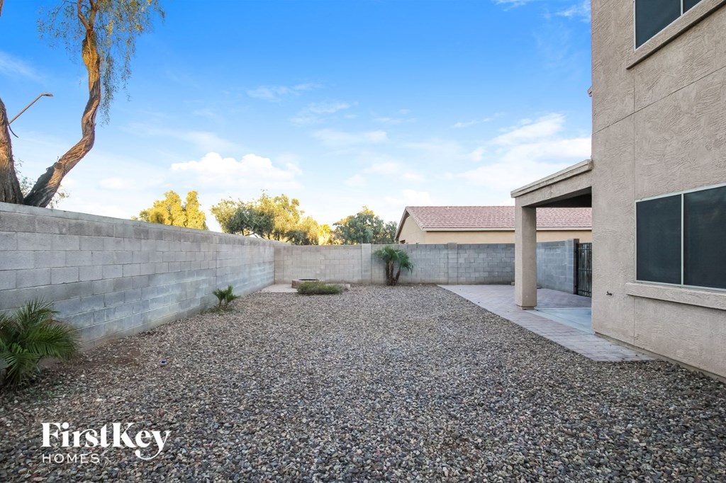 a large gravel driveway in front of a house