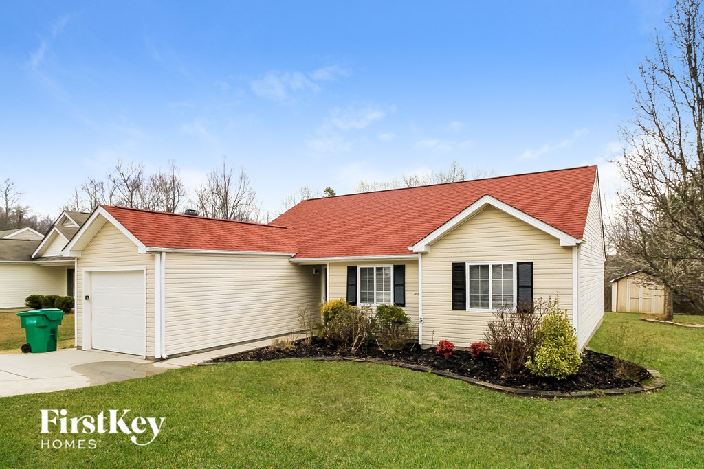 A house with a red roof and a white garage door.