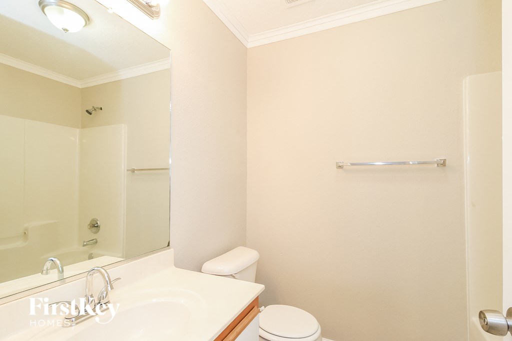 A white bathroom with a toilet and sink.