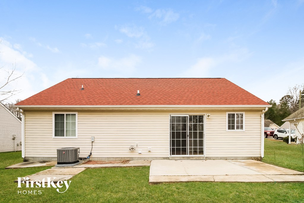A small house with a red roof and a sign that says "Firstkey Homes".