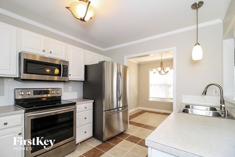 a kitchen with stainless steel appliances and white cabinets