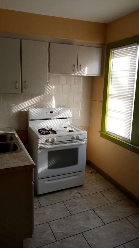 a kitchen with a stove and a sink