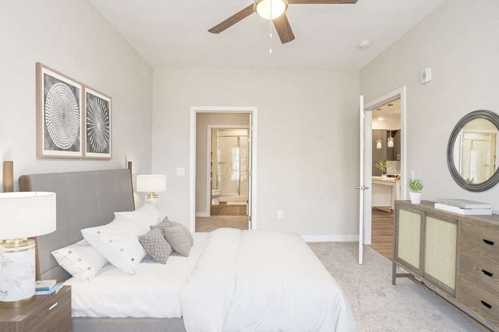 a bedroom with a large bed and a ceiling fan