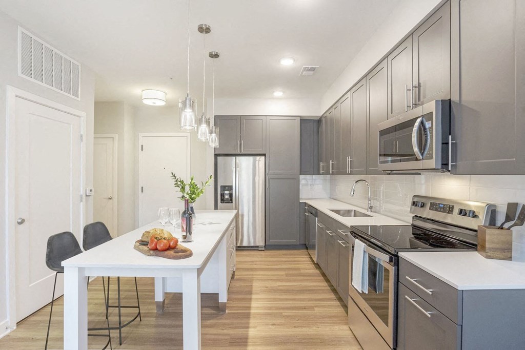 a kitchen with stainless steel appliances and a white table