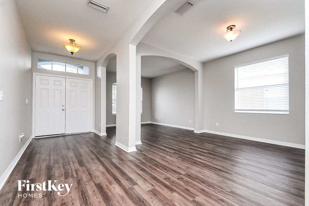the living room and dining room of an open floor plan
