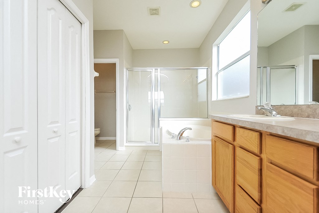 a bathroom with a shower and a sink and a mirror