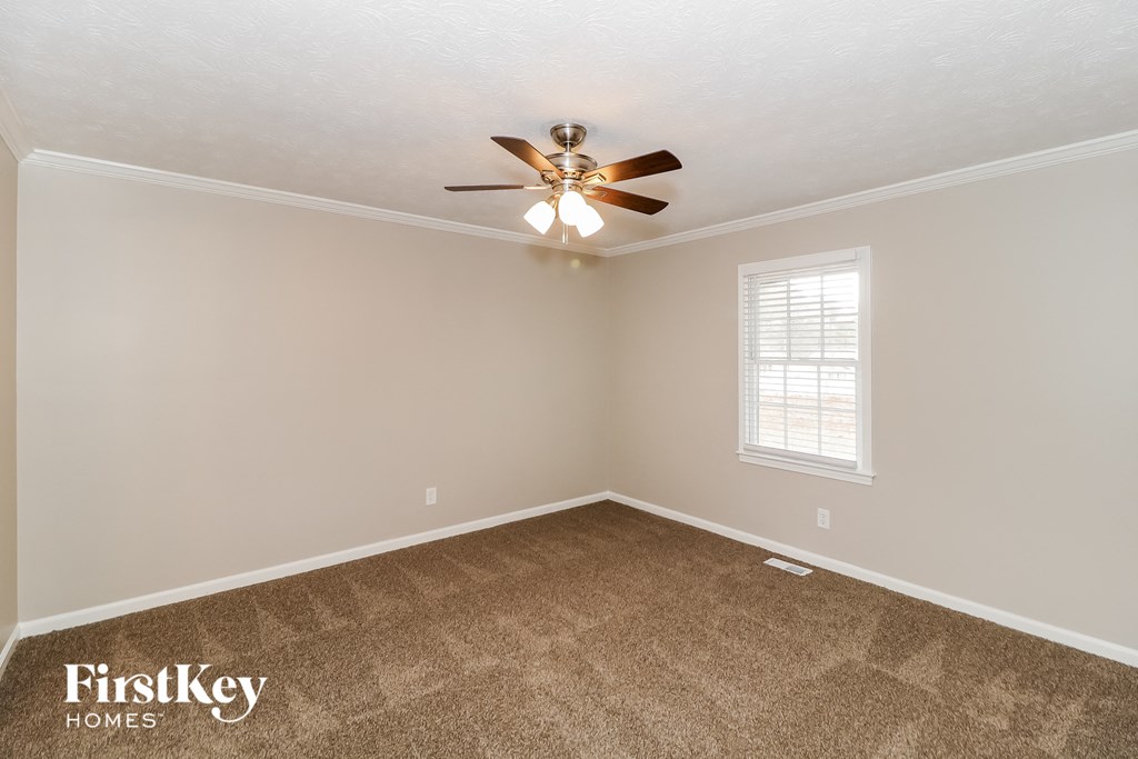 a bedroom with carpet and a ceiling fan