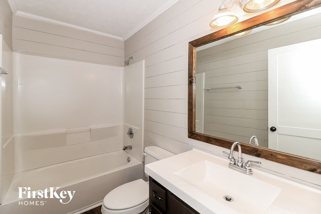 a bathroom with a sink and a toilet and a bath tub