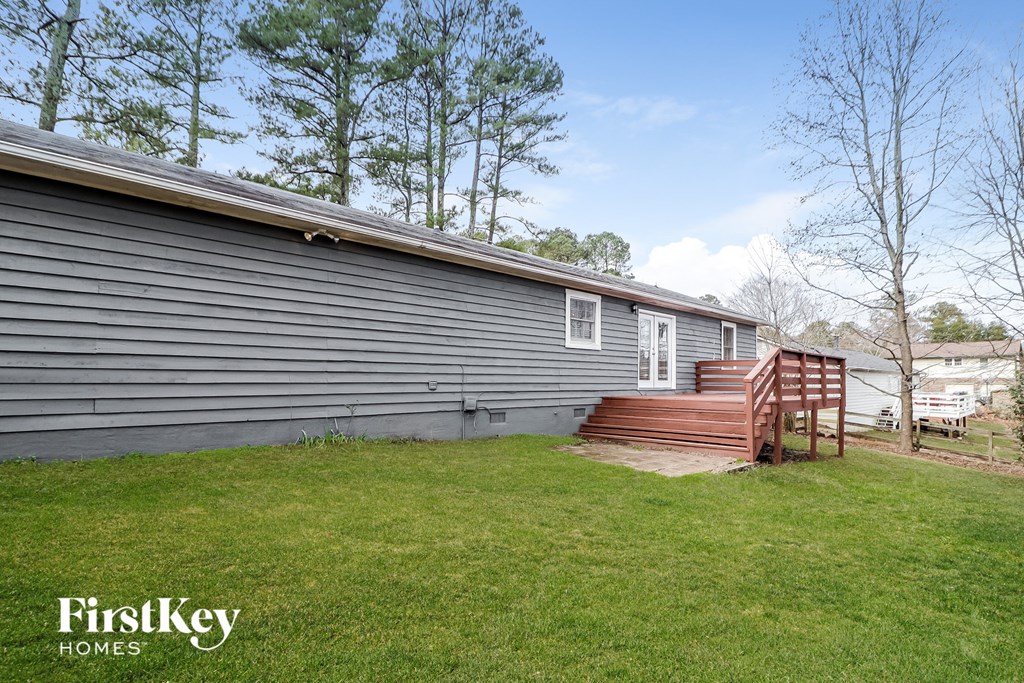 a home with a wooden deck in front of it