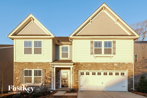 a yellow house with a white garage door