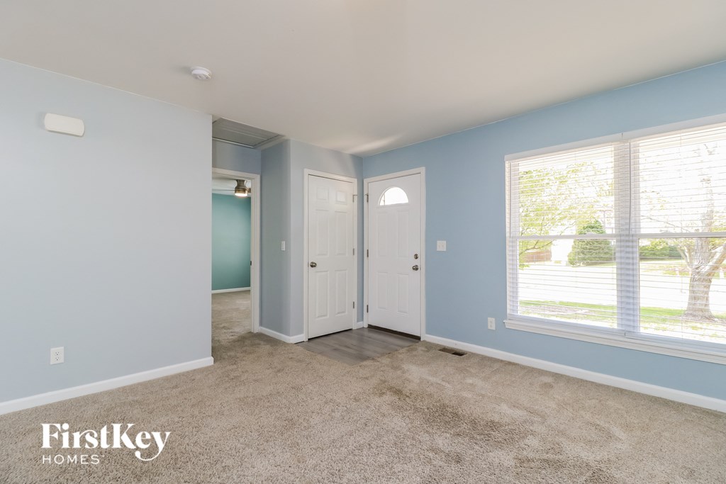 A room with light blue walls and a carpeted floor.