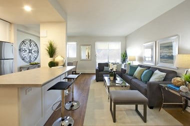 Laura Secord Apartments spacious living room with view into kitchen in Niagara Falls, ON