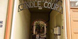 the entrance to candle court with an open gate