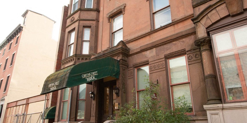 a building with a green awning in front of it