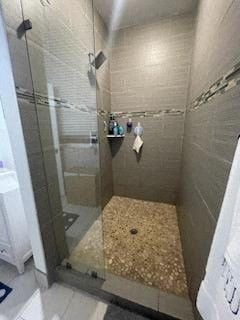a bathroom with a shower with a glass door