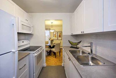 Bayview Apartments Sleek kitchen with view of the dining room, sink, oven and stove in Richmond Hill, ON