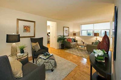 Bayview Apartments Large space with views of the living room and alternate seating area. Decorated with modern furniture and paintings in Richmond Hill, ON