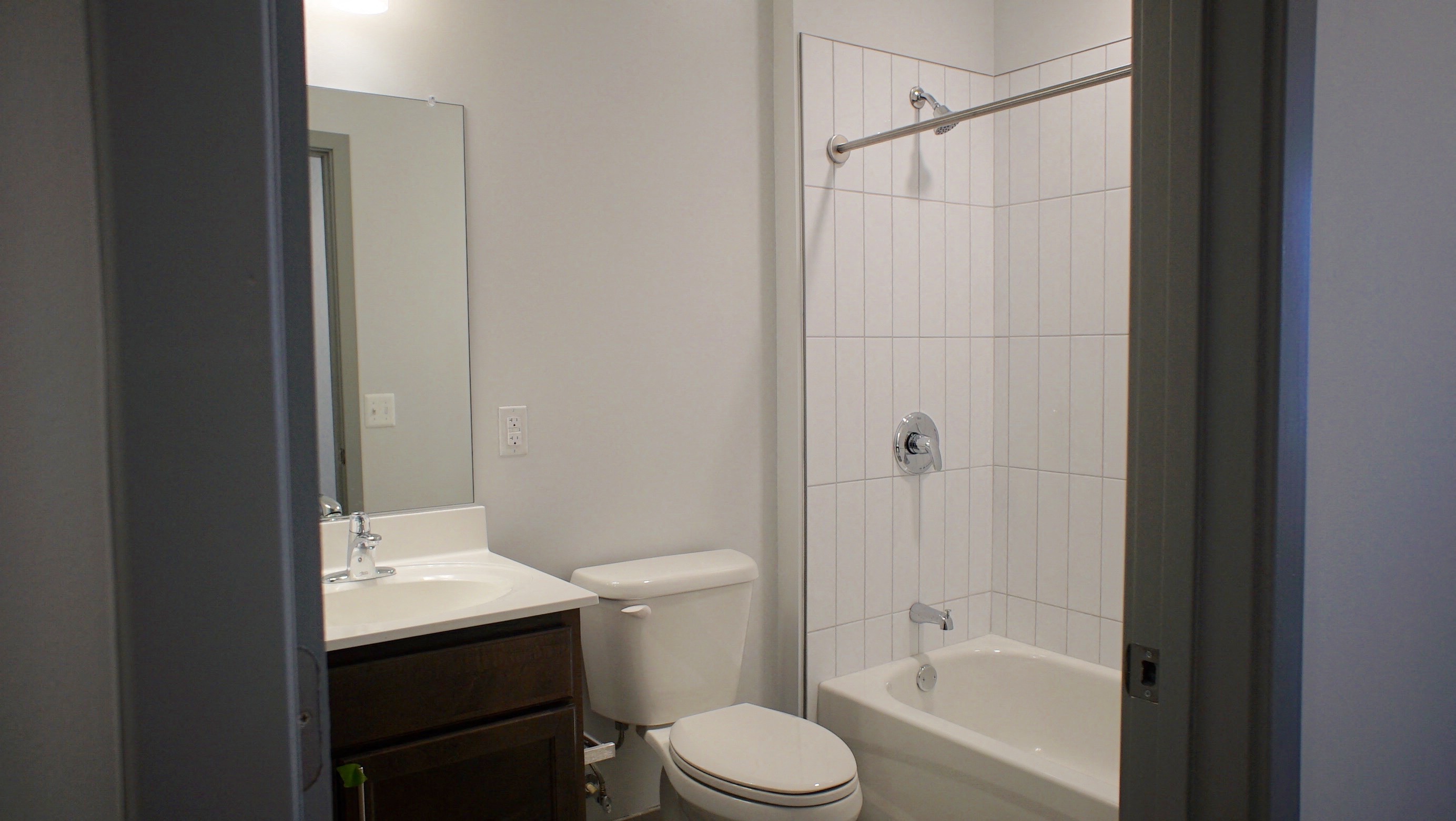 a small bathroom with a shower toilet and sink