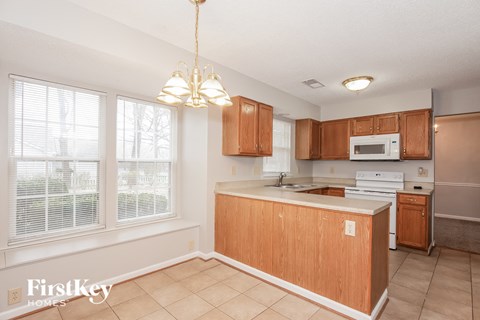 a kitchen with wood cabinets and a white counter top