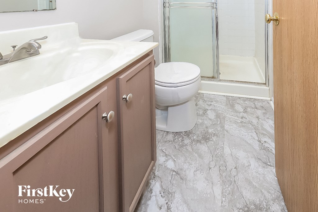 an image of a bathroom with a toilet and a sink